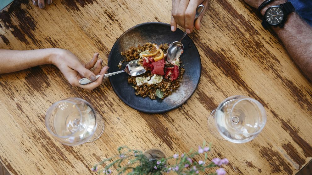 Couple enjoying food and drink at Zecca Restaurant, Griffith